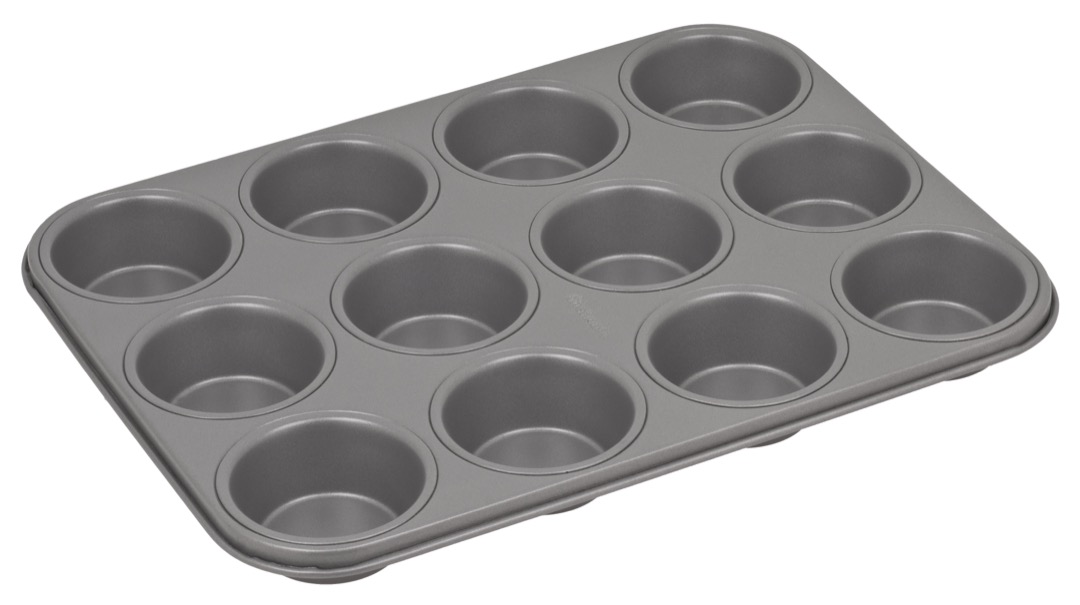 An empty twelve-cup muffin pan photographed from above on a white background